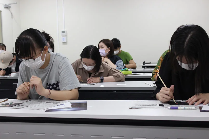 Participants creating artwork in a classroom