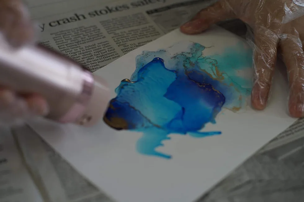 Hands creating with color during a program with Kochi University