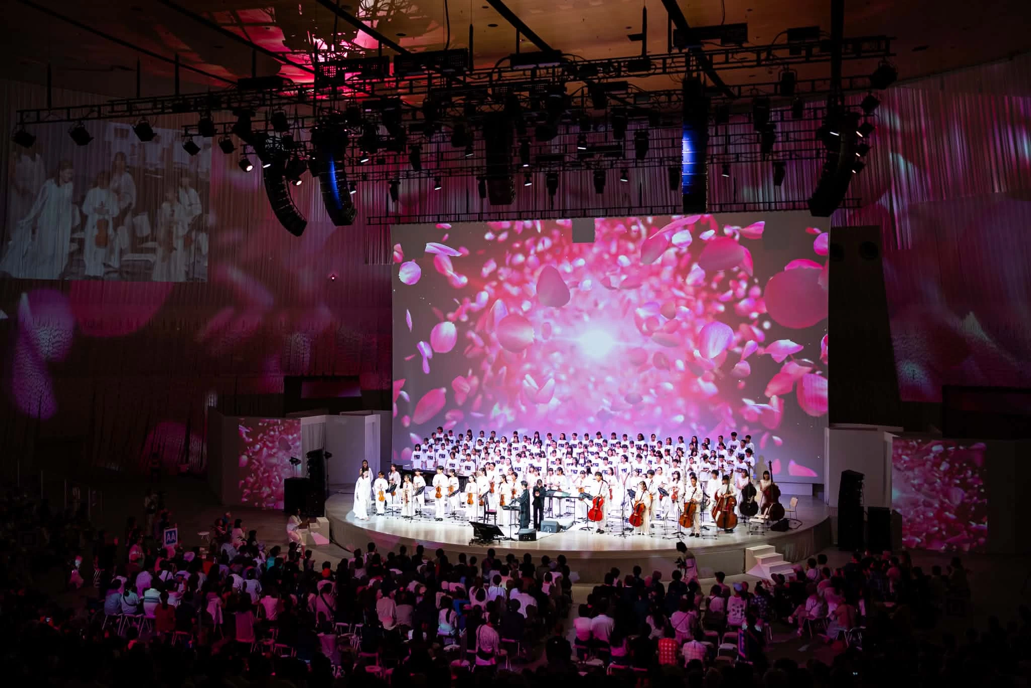 The Super Kids Orchestra and choir performing together with film imagery behind them