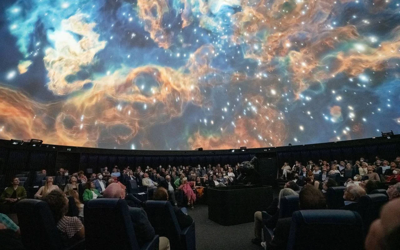 The dome audience surrounded by 360-degree images of a nebula